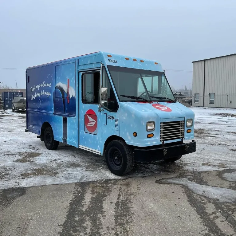 A Canada Post delivery van wrapped in a holiday themed printed vinyl wrap