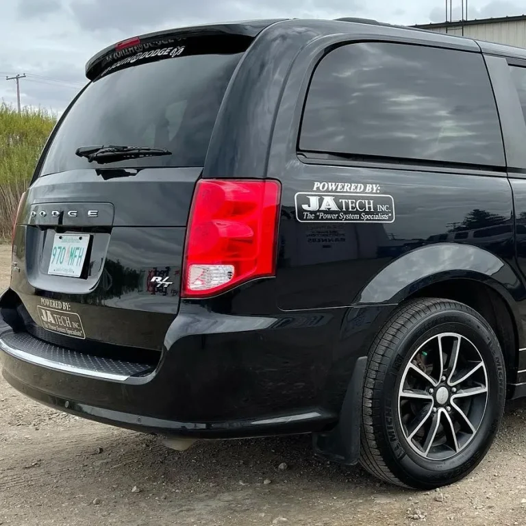 A black Dodge van with rear tinted windows