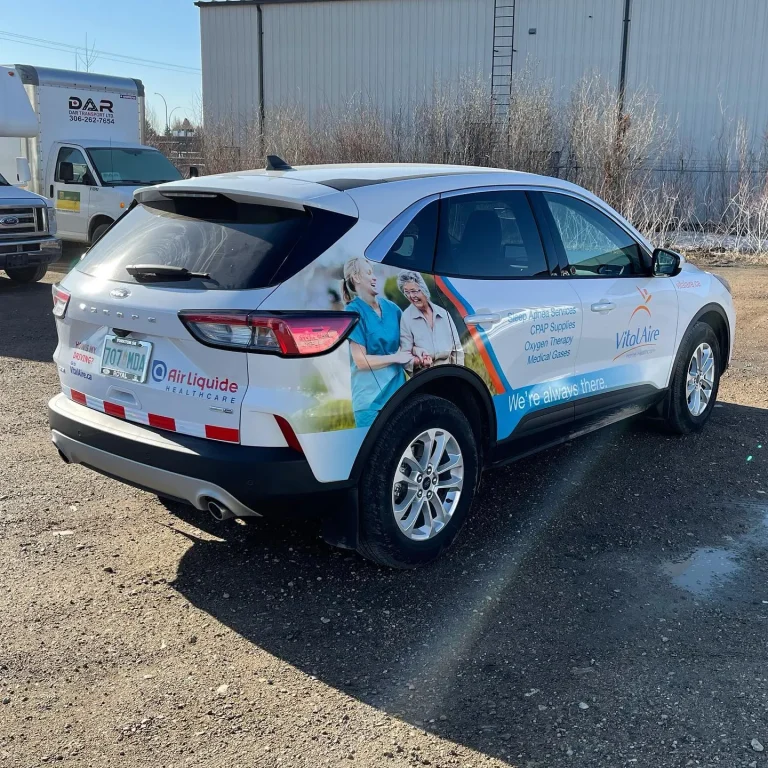 A white SUV with custom graphics on the side and rear door