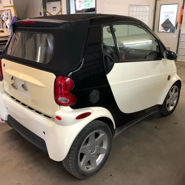 A White smart car with black accents