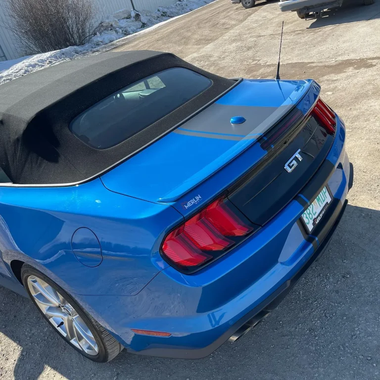 A blue Mustang with racing stripes.