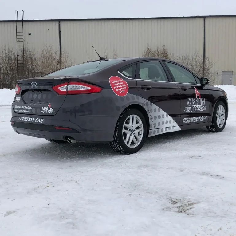 A dar grey sedan with custom wrapped graphics