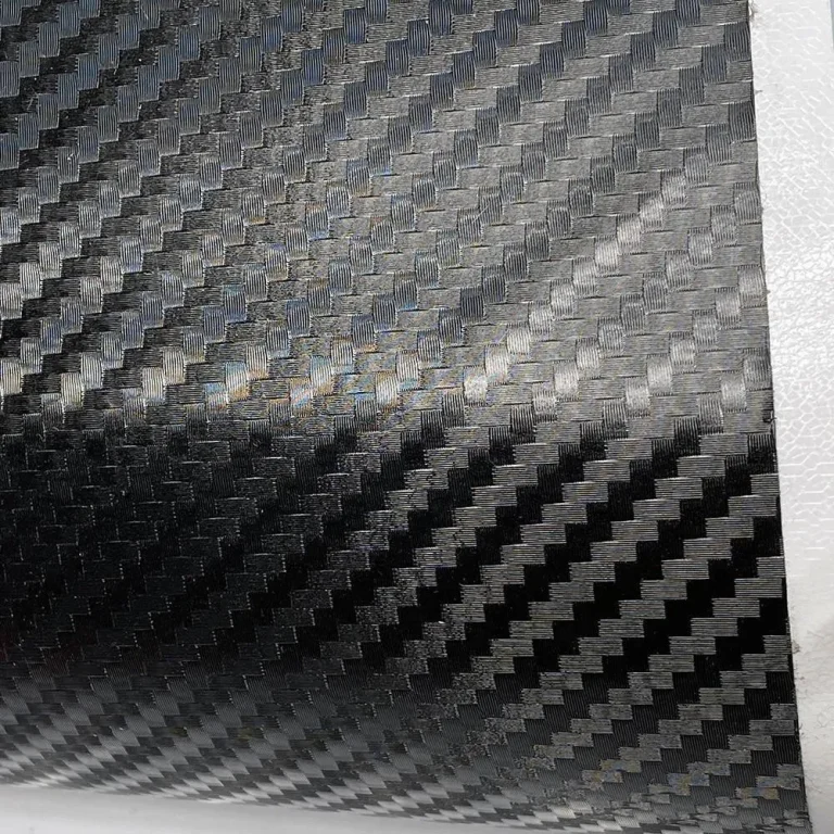 A closeup of a sheet of carbon fibre vinyl to show texture and black colour.