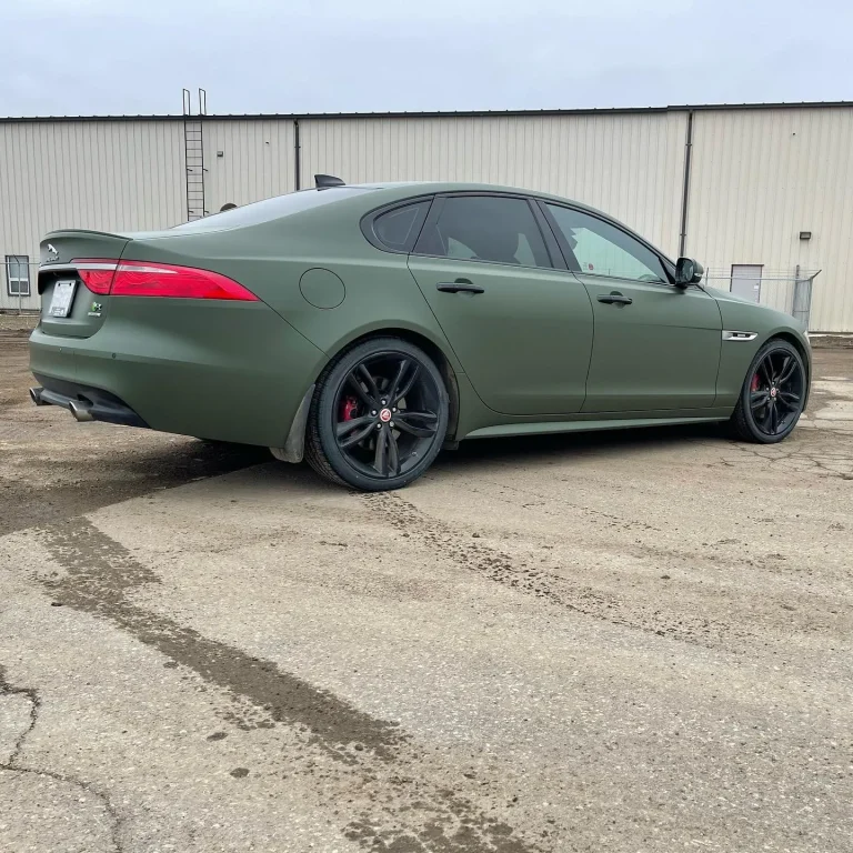 A Jaguar car with green vinyl wrap.