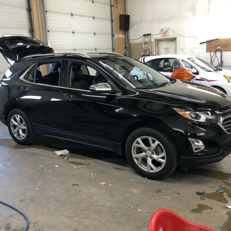A black SUV with shiny colour change wrap