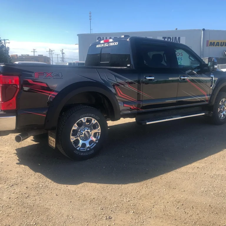 A black pickup truck with graphics on the side.