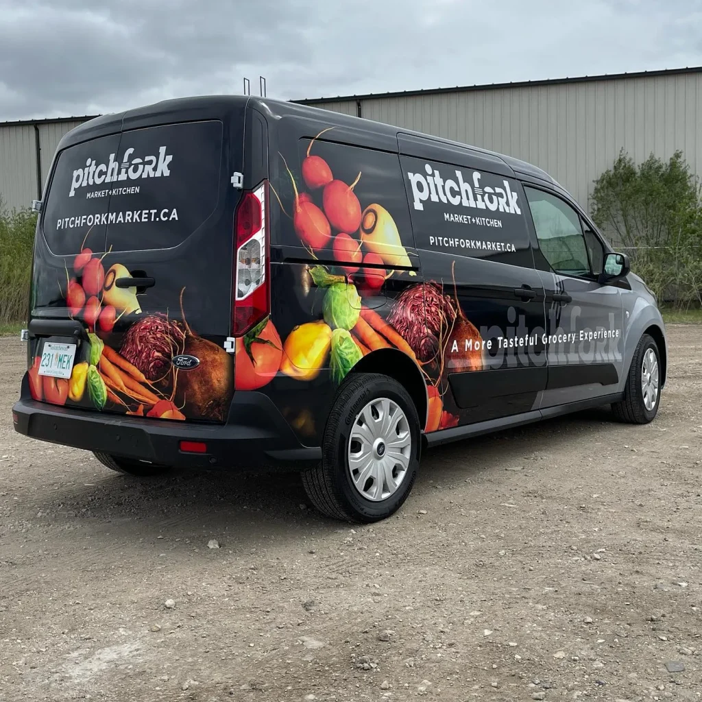 A work van with custom graphics on the side and rear.