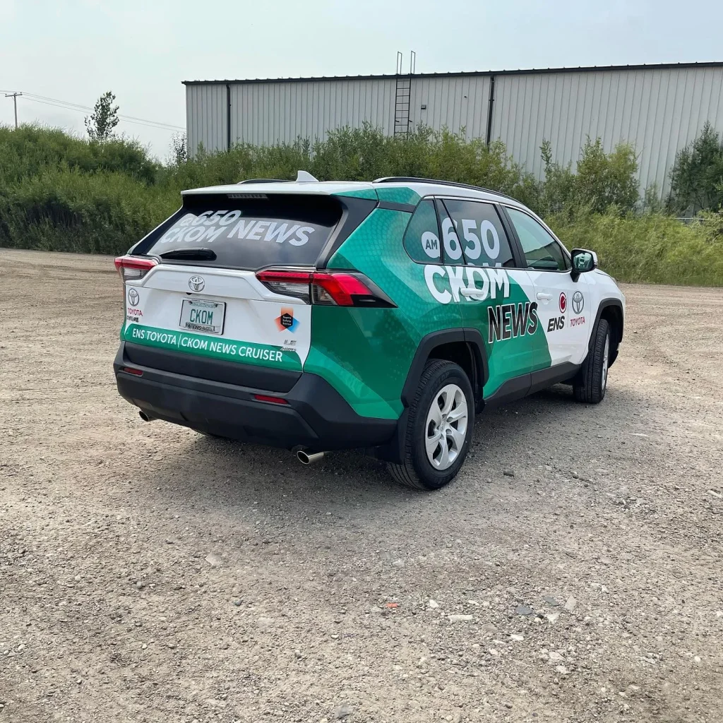 A SUV with custom designed wrap down the side and rear.