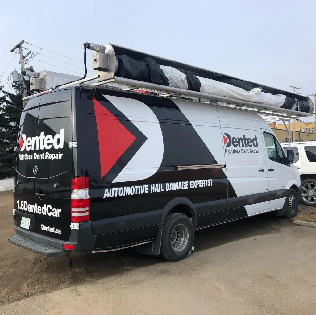 A work van with graphics on the sides and rear.