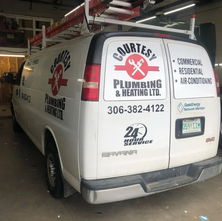 A work van with logo and lettering on the side and back.