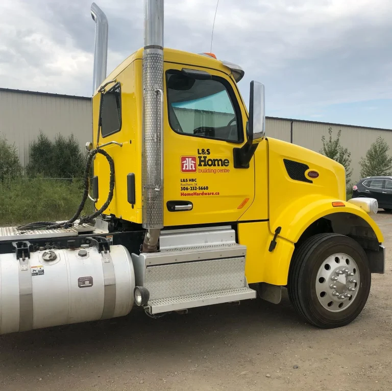 A yellow semi truck cab with company lettering.