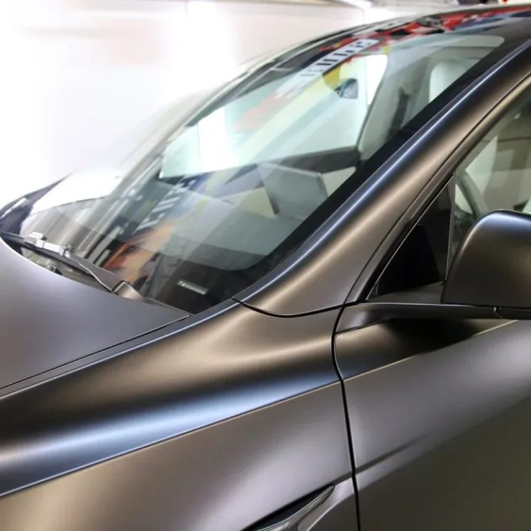 The front pillar of a car with satin vinyl wrap.