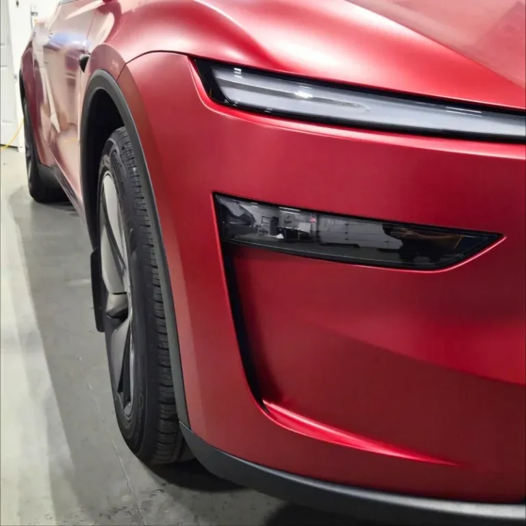 Front end of a Tesla wrapped in red vinyl.