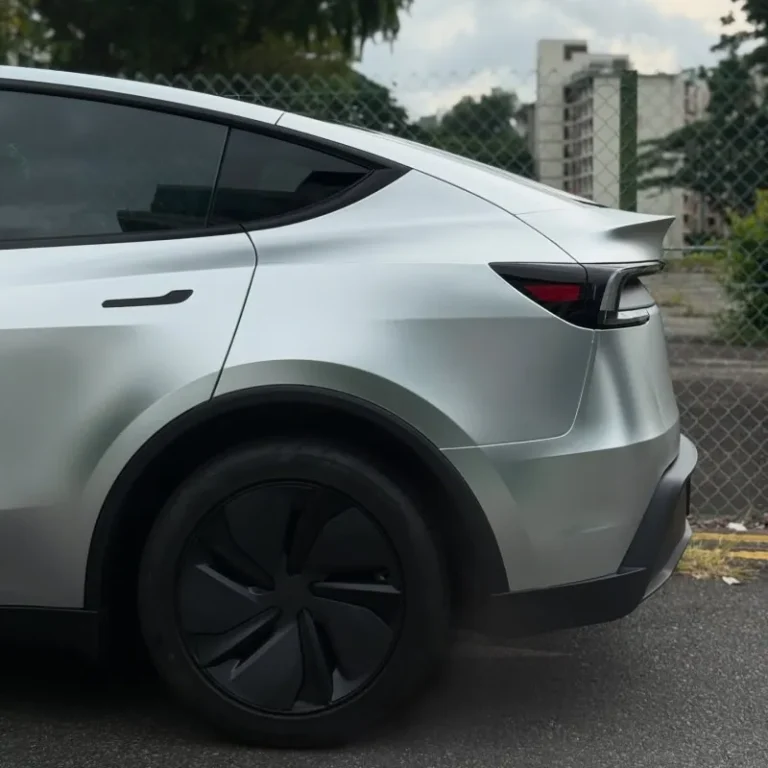 Rear end of a Tesla wrapped in silver vinyl.
