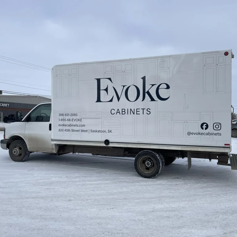 A box truck with company logo and information on the side.
