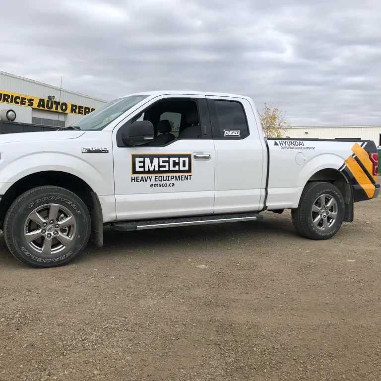 A white truck with logo and text on the door.