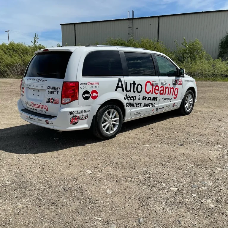 A white Dodge van with company branding