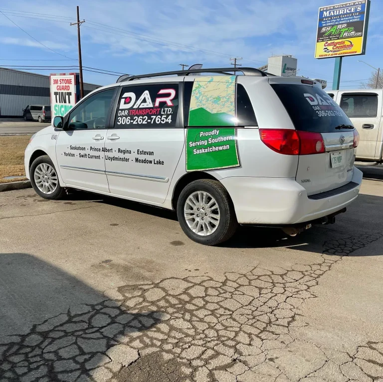 A white van with company logo and branding on the side.
