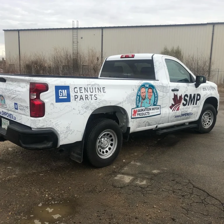 A white truck with custom graphics and logos on the side and rear.